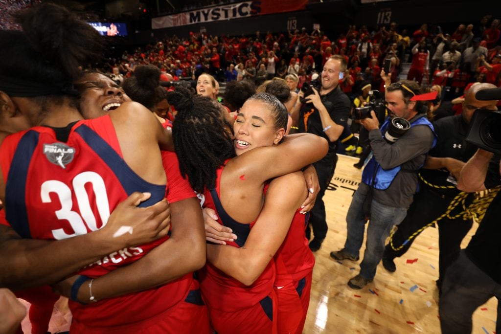 Natasha Cloud and Ariel Atkins hug after winning their first WNBA Championship.