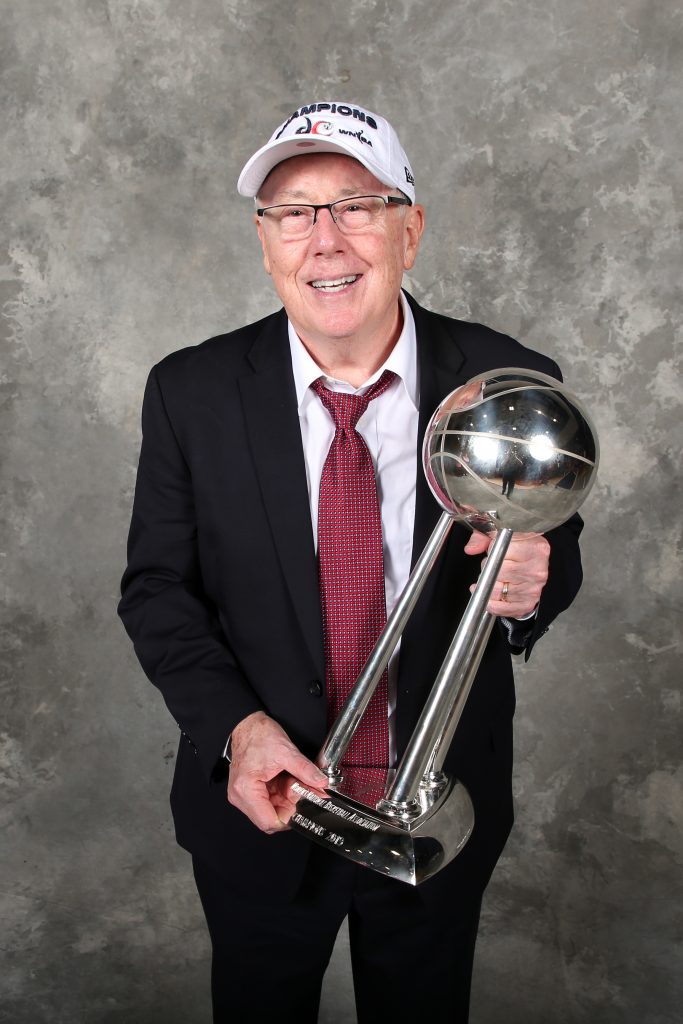 The winningest coach in WNBA history, Mike Thibault, poses with the WNBA Finals trophy.