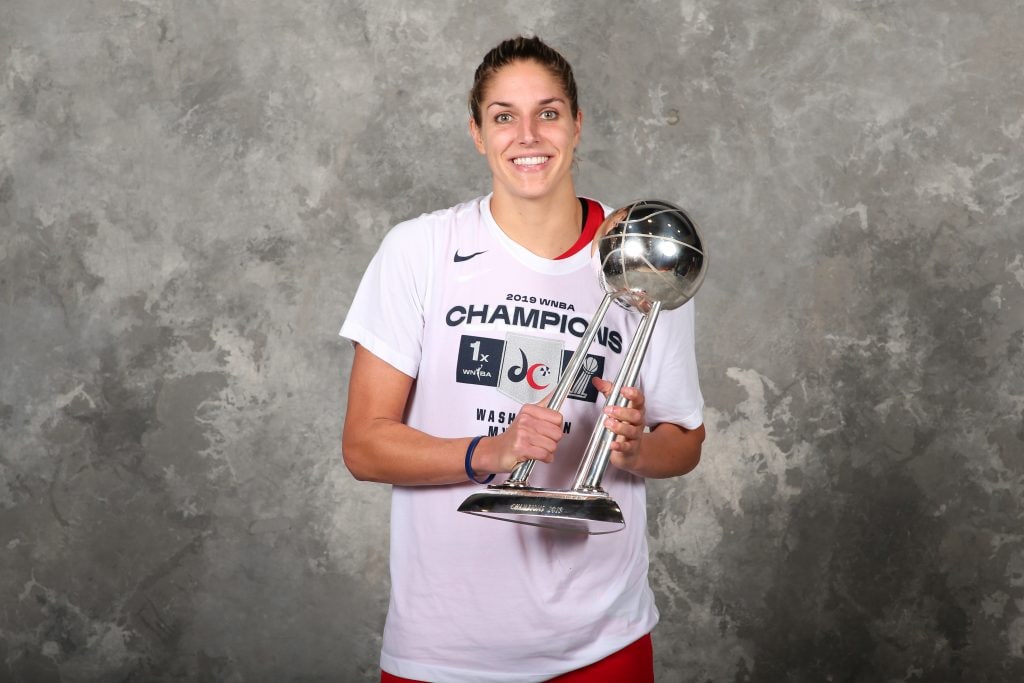 WNBA MVP poses with the WNBA Finals trophy.