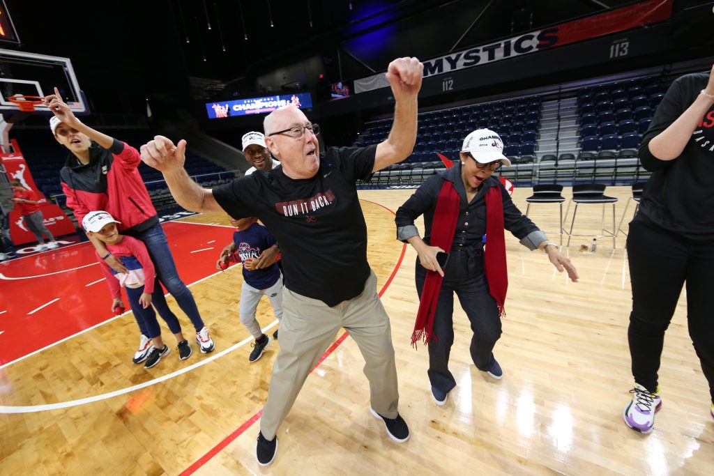 Head coach Mike Thibault celebrates at the Mystics' Chapionship rally.